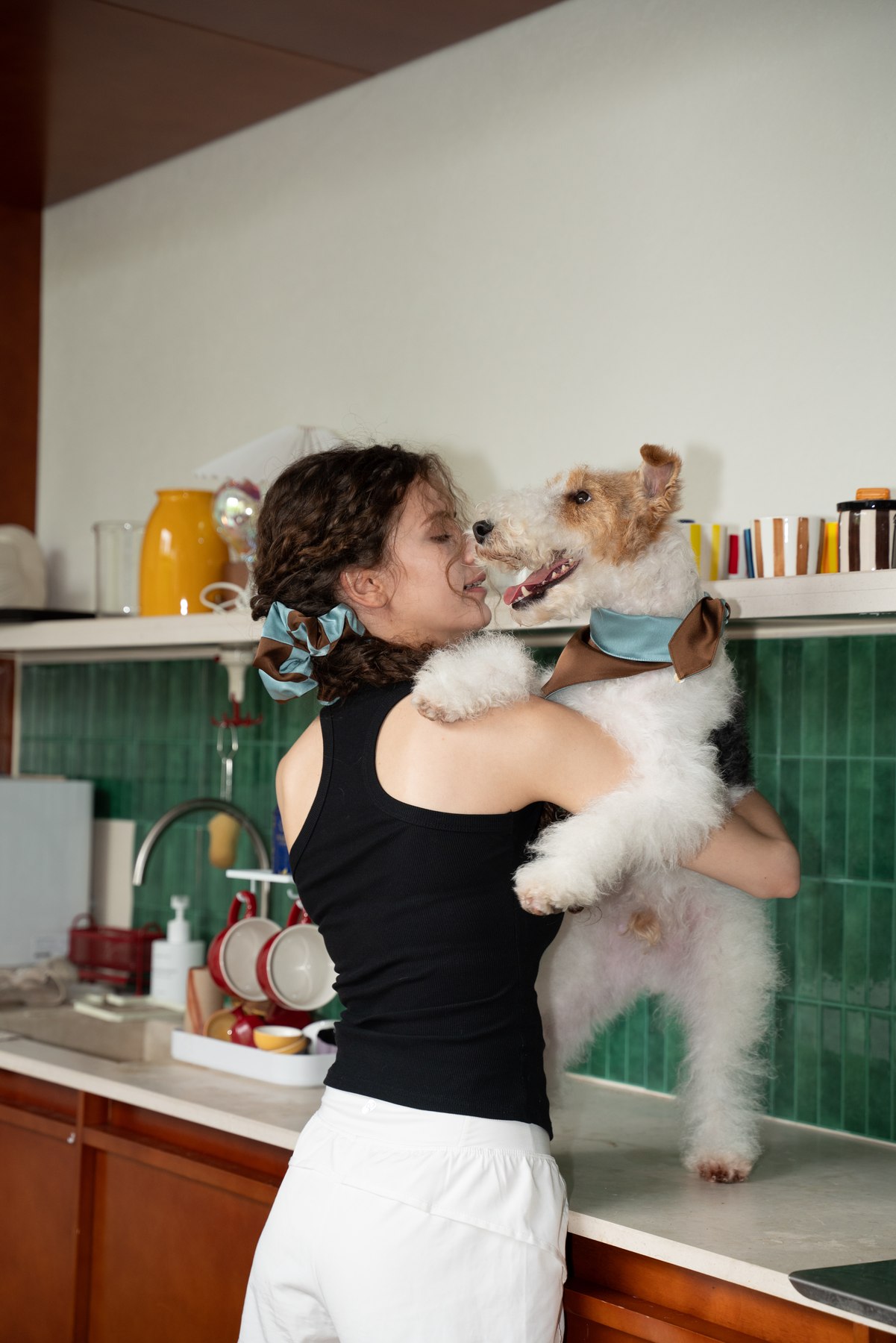 Woman sharing an affectionate moment with her dog in a Mocha Sky matching set